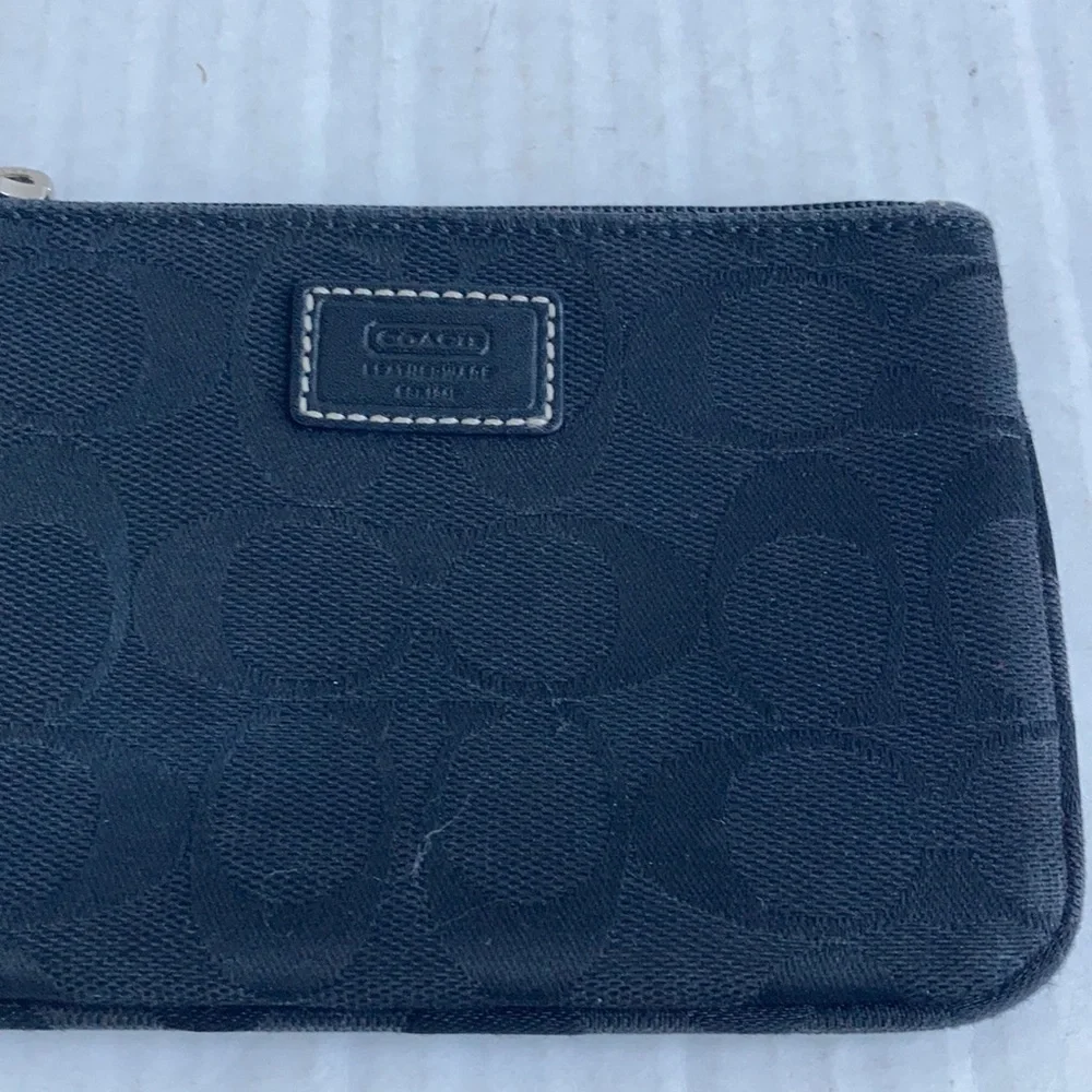 Coach black signature C mini wristlet.